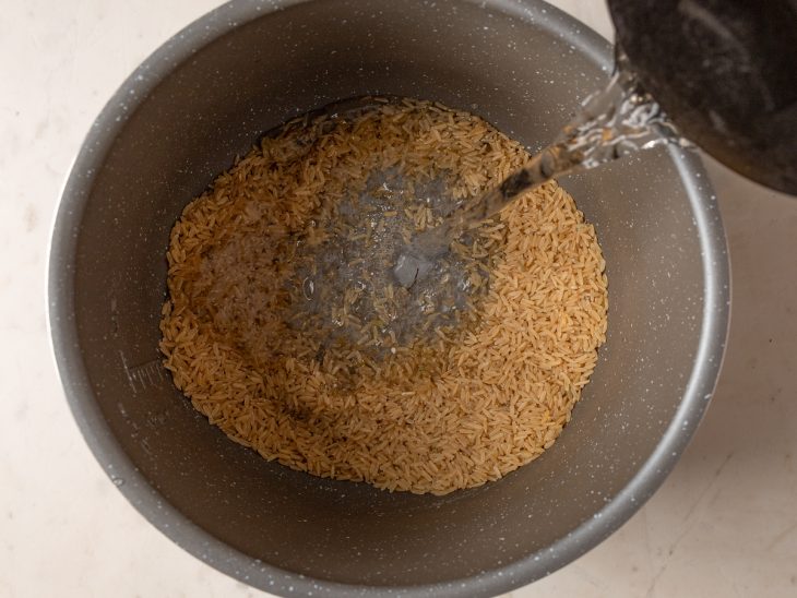 Ingredientes adicionados na panela com arroz integral.