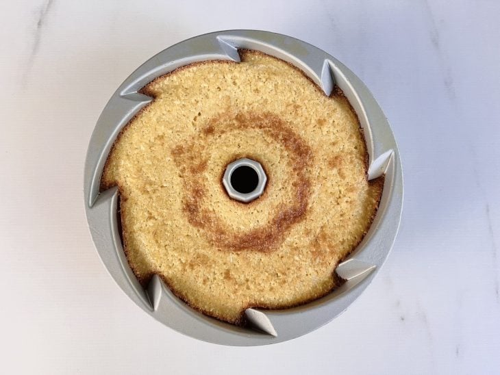 Bolo de farinha de milho biju com coco assado em uma forma.