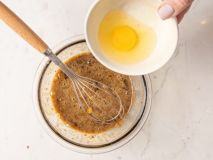 Uma tigela com a mistura de açúcar mascavo, açúcar cristal e ovos.