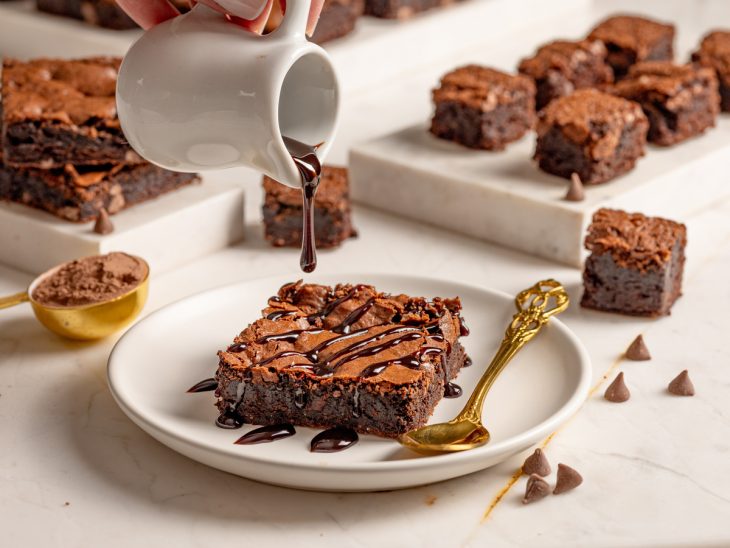 Pratos contendo brownie com calda de chocolate.