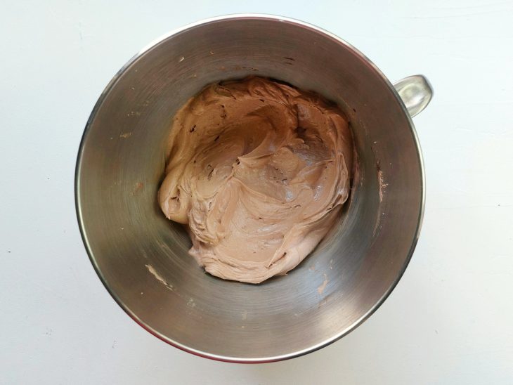 Uma tigela com o creme de manteiga e a adição do chocolate derretido.