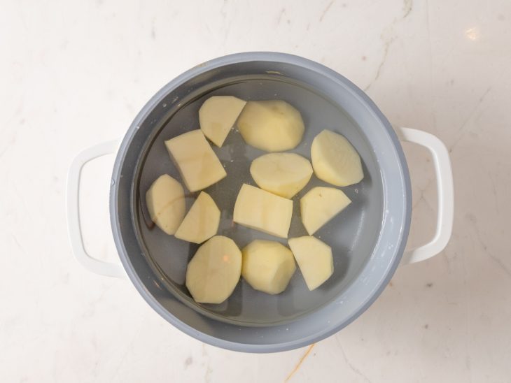 Batatas cortadas em uma panela com água