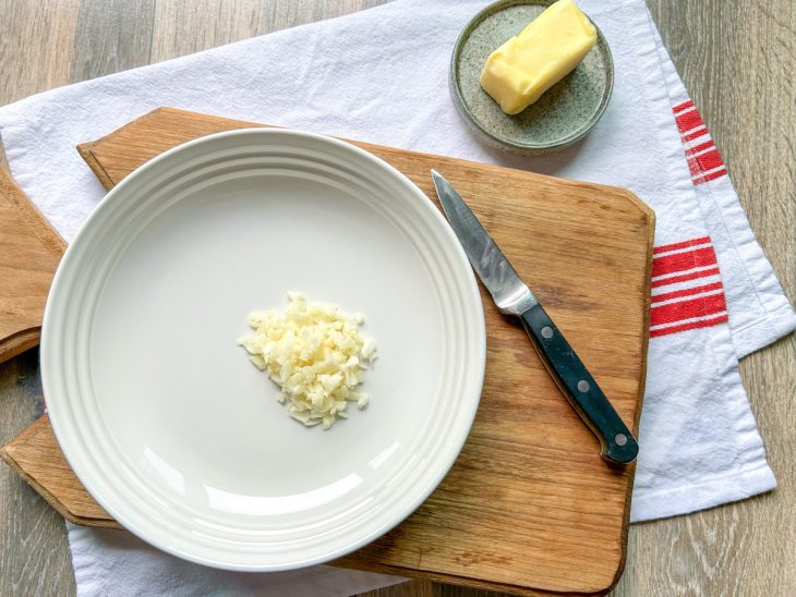 Alho picado e manteiga em recipientes.