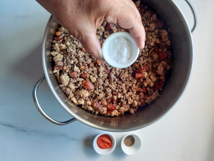 Uma panela com a mistura de carnes e temperos.