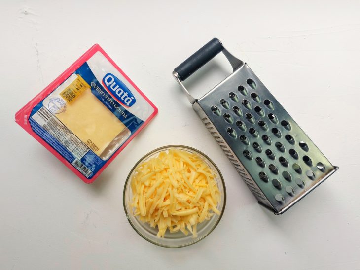 Um recipiente com queijo ralado.