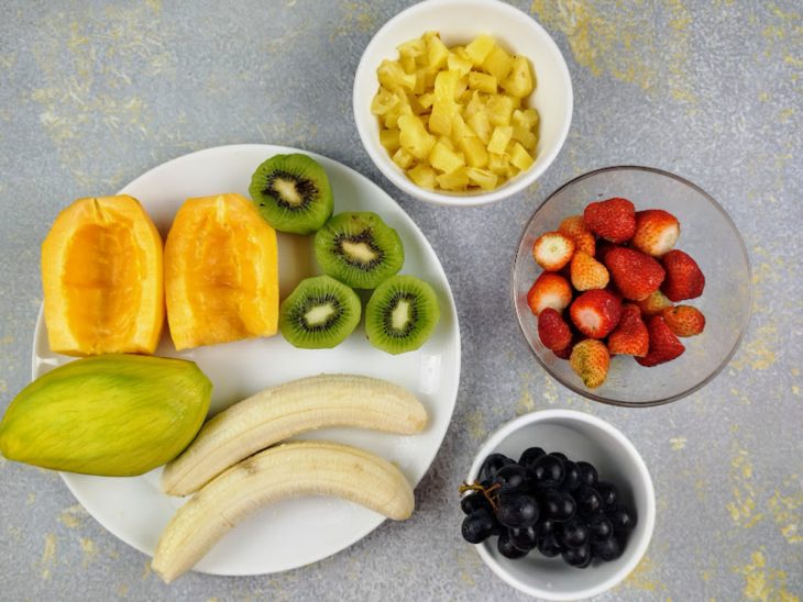 Frutas higienizadas em recipientes.