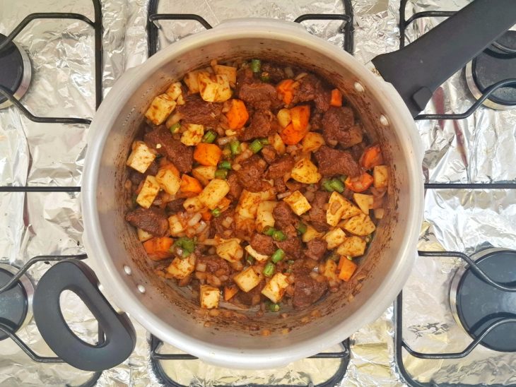 Vegetais adicionados na panela com carne.